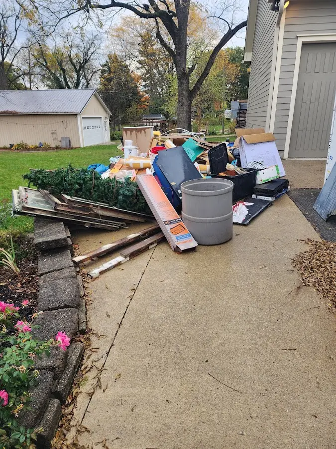 Dumpster being loaded with debris for 12 Yard Dumpster Rental in Morgan's Point Resort
